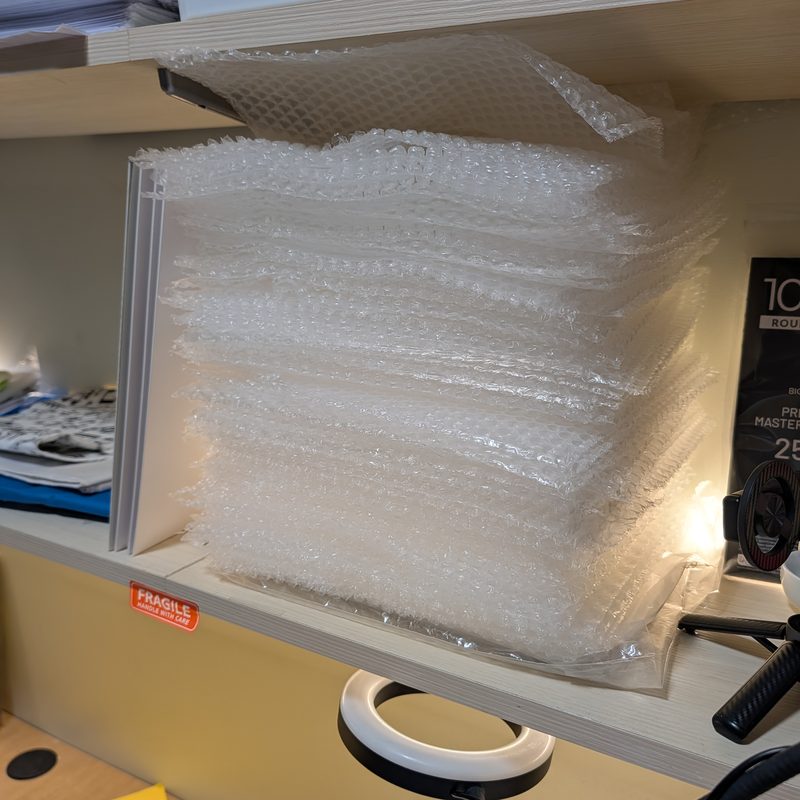 A stack of small bubble cushioning wrap on the packing shelf