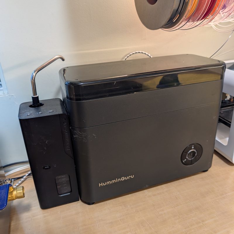 The HumminGuru ultrasonic cleaner beside its water tank