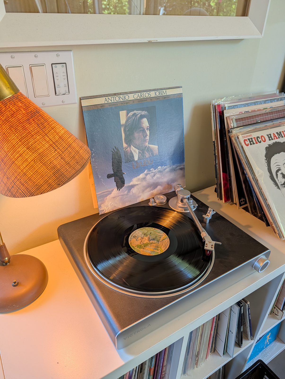 Urubu LP spinning on turntable with sleeve propped behind it